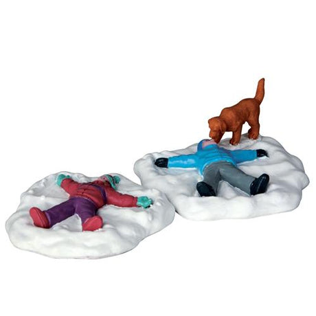 Village accent for a Lemax display. Designed to look like two young kids making snow angels on the ground. They're wearing winter clothes and there's a dog watching.