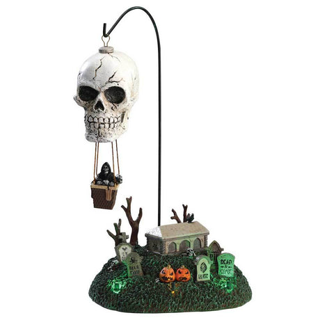 Porcelain accent for a Lemax display. Designed to look like a hot air balloon shaped like a skull flying above a cemetery.