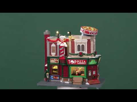 Resin lighted building for a Lemax display. Designed to look like a pizza shop. It's decorated for Christmas and there's snow on the sidewalk. Inside the window, you can see a chef spinning dough in the air. There's a circular pizza sign on the roof.
