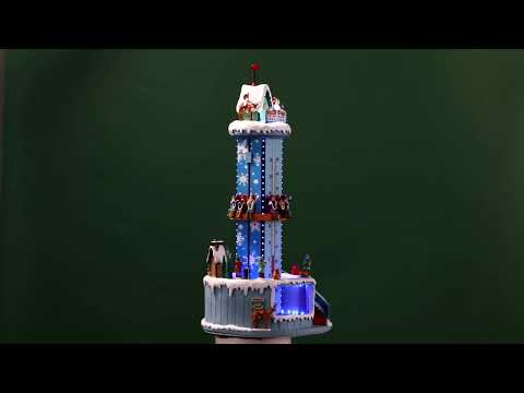 Resin village accent for a Lemax display. Designed to look like a winter-themed carnival ride. Santa and a reindeer stand on the top. There are people on the ride and people standing in line. The backdrop of the ride is designed to look like a thermometer.