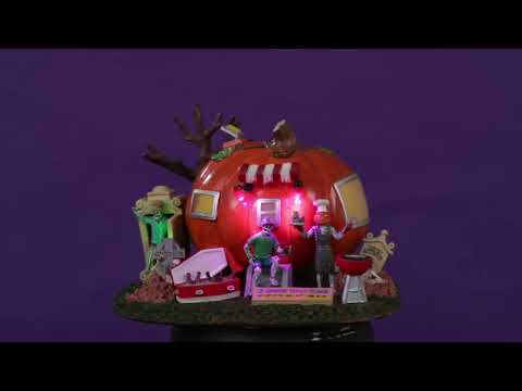 Resin lighted building for a Lemax display. Designed to look like a camper made out of a large pumpkin. There are skeletons enjoying a BBQ.