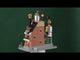 Polyresin lighted building for a Lemax display. Designed to look like a Christmas themed factory. There's an elf sitting on top of the roof. Signs read "Milk Chocolate," "Dark Chocolate," "Truffle Factory, "Kitchen" and "Chocolate." There's a display of truffles in the front window and a bunch of elves working hard.