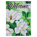 A green flag that reads "WELCOME" and features a bunch of white flowers with green stems